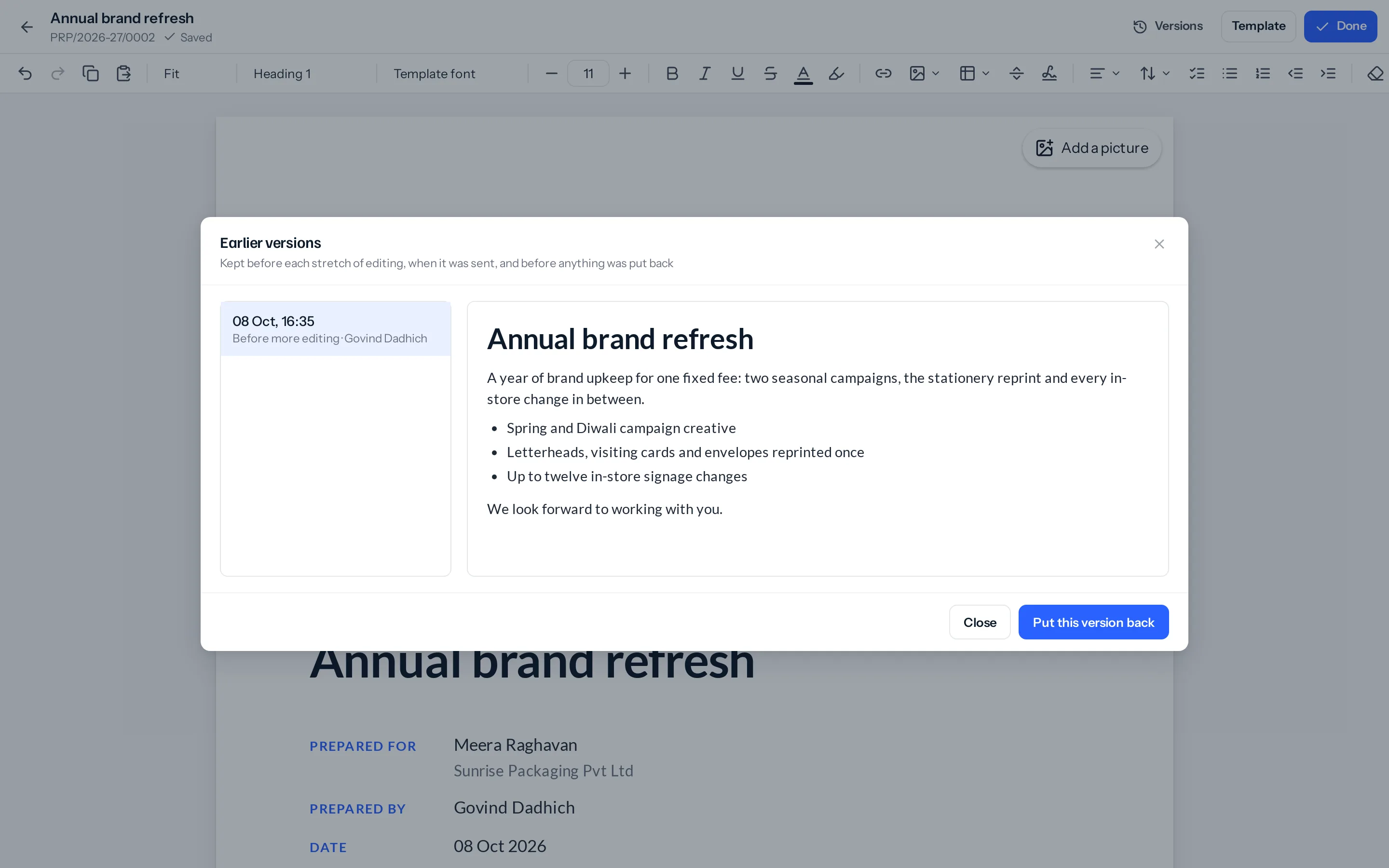The Earlier versions window over the designer: one version on the left, 08 Oct, 16:35, Before more editing, Govind Dadhich, chosen; on the right its pages, the Annual brand refresh heading, a paragraph, three bullets and a closing line; Close and Put this version back below.